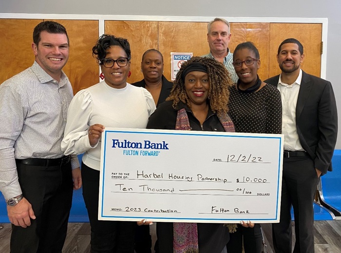 a group of people donating a check